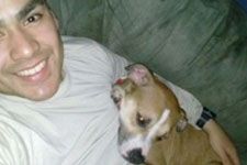 A man sitting on a couch with a dog.