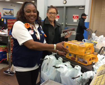 Walmart employees helping a customer.